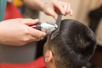 Obraz na płótnie Canvas Man's haircut trimmer in the beauty salon
