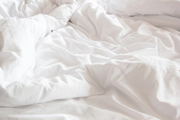 wrinkle messy blanket and white pillow in bedroom after waking up in the morning, from sleeping in...