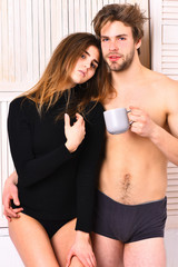 couple of bearded man with cute sexy girl holding cup