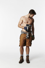 Construction worker, shirtless with tools