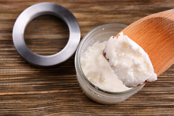 Fresh coconut oil on wooden spatula, closeup