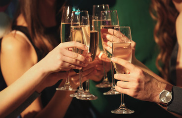 Friends clinking glasses at party, closeup