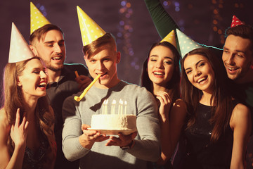 Friends having fun at birthday party in night club