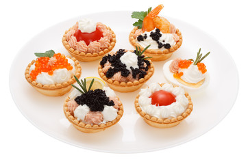 Set tartlets on a white plate.