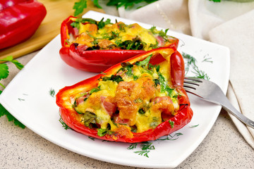 Pepper stuffed with sausage and cheese in white plate on table