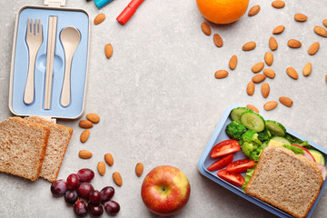 Lunch box with delicious food, fruits and almond on light textured background