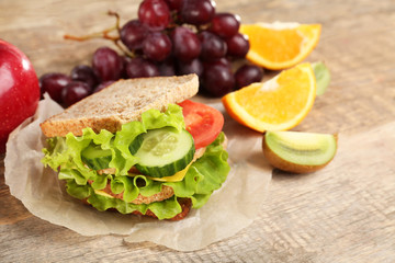 Delicious food and fruits on wooden background