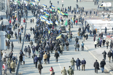 Crowd of people walking on busy city street