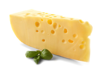 Piece of tasty cheese and basil on white background