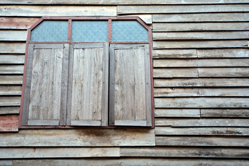 Old wooden house wall with wooden window. texture background