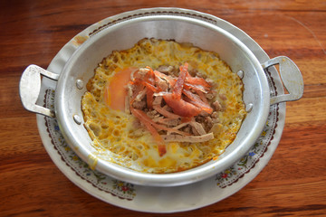 fried egg in pan with white pork sausage