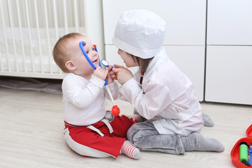 Little 4 years brother and 10 months sister play doctor at home