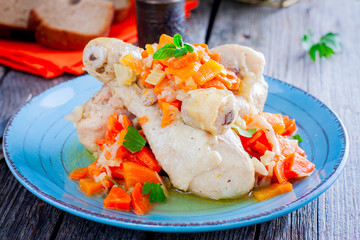 Stewed chicken drumsticks with carrots, onions and celery, selective focus