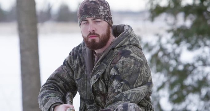 hunter with beard lowers his shotgun slow motion 4k