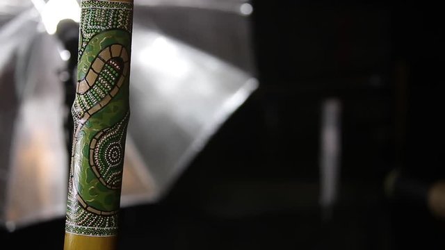 dot art of python snake on didgeridoo turning in art studio