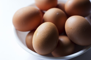 A closeup shot of eggs in a bowl. A food concept.