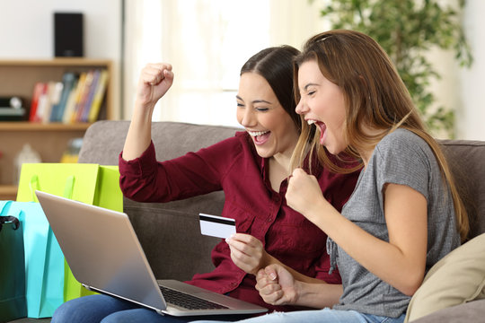 Excited friends buying online with credit card