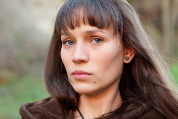 Naklejka premium Sad brunette woman in the park