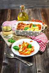 Stuffed pasta shells casserole with gorgonzola, ricotta and tomato sauce