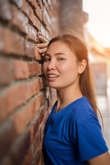 Woman smiling with perfect smile  in a park and looking at camera