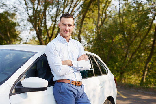 Handsome Man Standing In Front Of Car