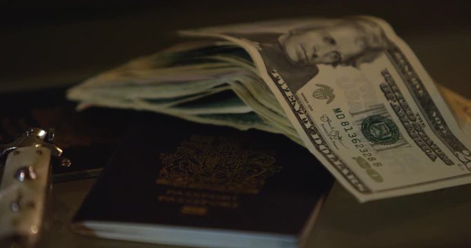 passports and cash panning slow motion focus pull