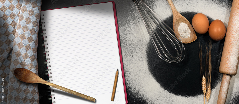Poster baking background with empty notebook on a table with flour, eggs and kitchen utensils