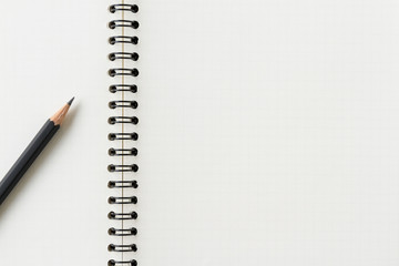 Close up of blank spiral notebook and pencil.