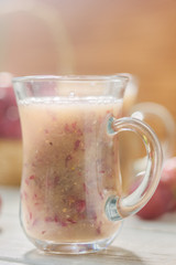 Grape smoothie over the white table.