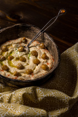 Homemade Chickpea Hummus in Rustic Bowl with Olive Oil and Fresh Pita Bread