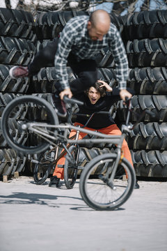 Cheerful man performing a stunt on bicycle