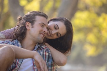 Fototapeta premium Young couple smiling in park