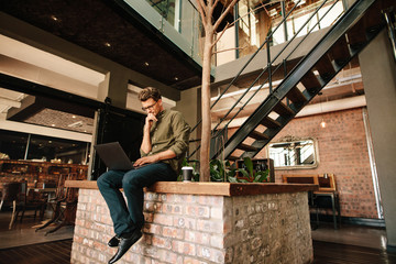 Executive using laptop during coffee break