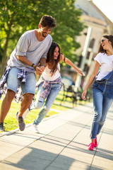 Fototapeta premium Group of happy young friends hangout and having fun at the city street.