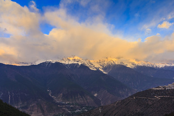 Meili snow mountain in sunrise and golden light at mountain peak, Feilai temple, Deqing, Yunnan, China