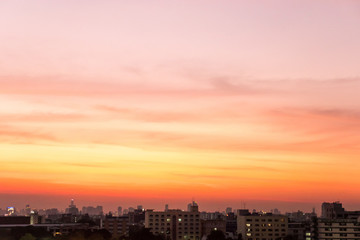 Fototapeta na wymiar Twilight sunset at city with building silhouette.