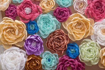 Background with a lot of colorful artificial flowers