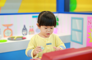 Little girl playing pretend as a sale in ice-cream shop