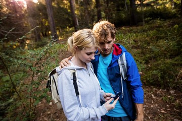 Hiking couple checking the compass