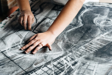 Young artist painting with charcoal
