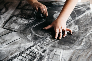 Young artist painting with charcoal