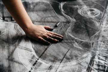 Young artist painting with charcoal
