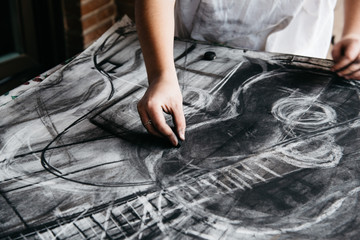 Young artist painting with charcoal