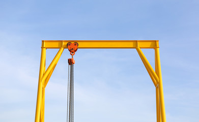 Crane for construction cradles against blue sky