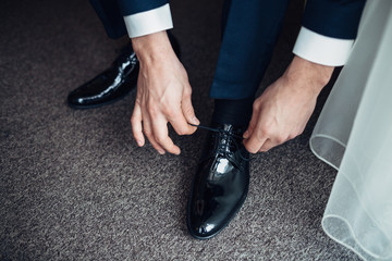 Man fixes his lacquer leather shoes