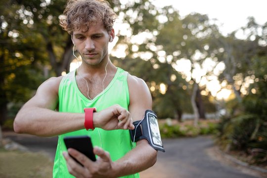 Jogger listening to music on mobile phone 