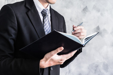 Close up of businessman checking documents on grunge background.
