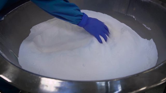 During the manufacturing process at a chemical plant control kompanentov purity. Specialist in haschitnom suit and glove evaluates the quality of the mixture