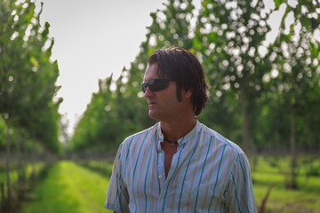 Attractive mature man with black glasses contemplates nature