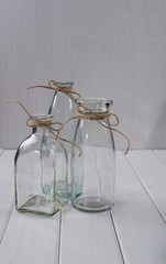 Three glass empty bottles for flowers